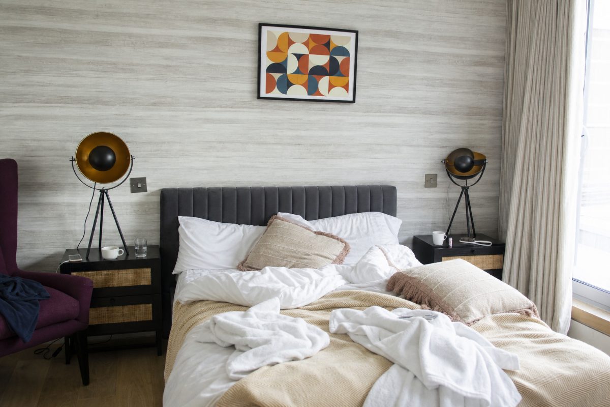 Illustrative hotel bedroom before a professional cleaning reset