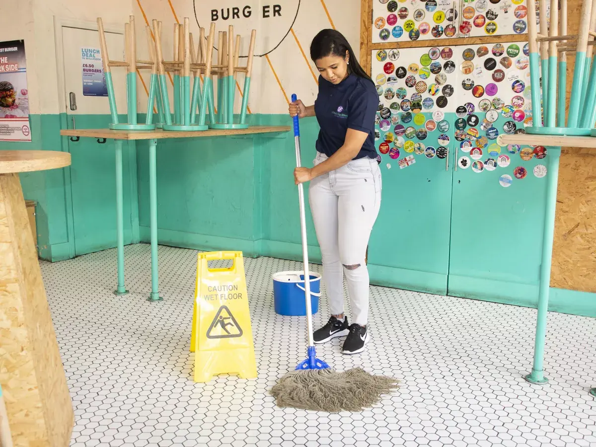 UF Cleaning professional mopping a commercial hospitality venue